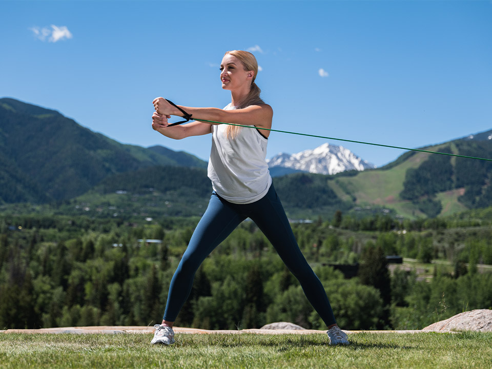 adding tubing to your exercise routine is beneficial-woman using tubes to work her arms fitforever online personalized fitness programs